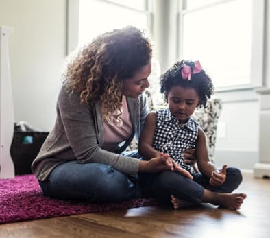 Adult reading to a young child.